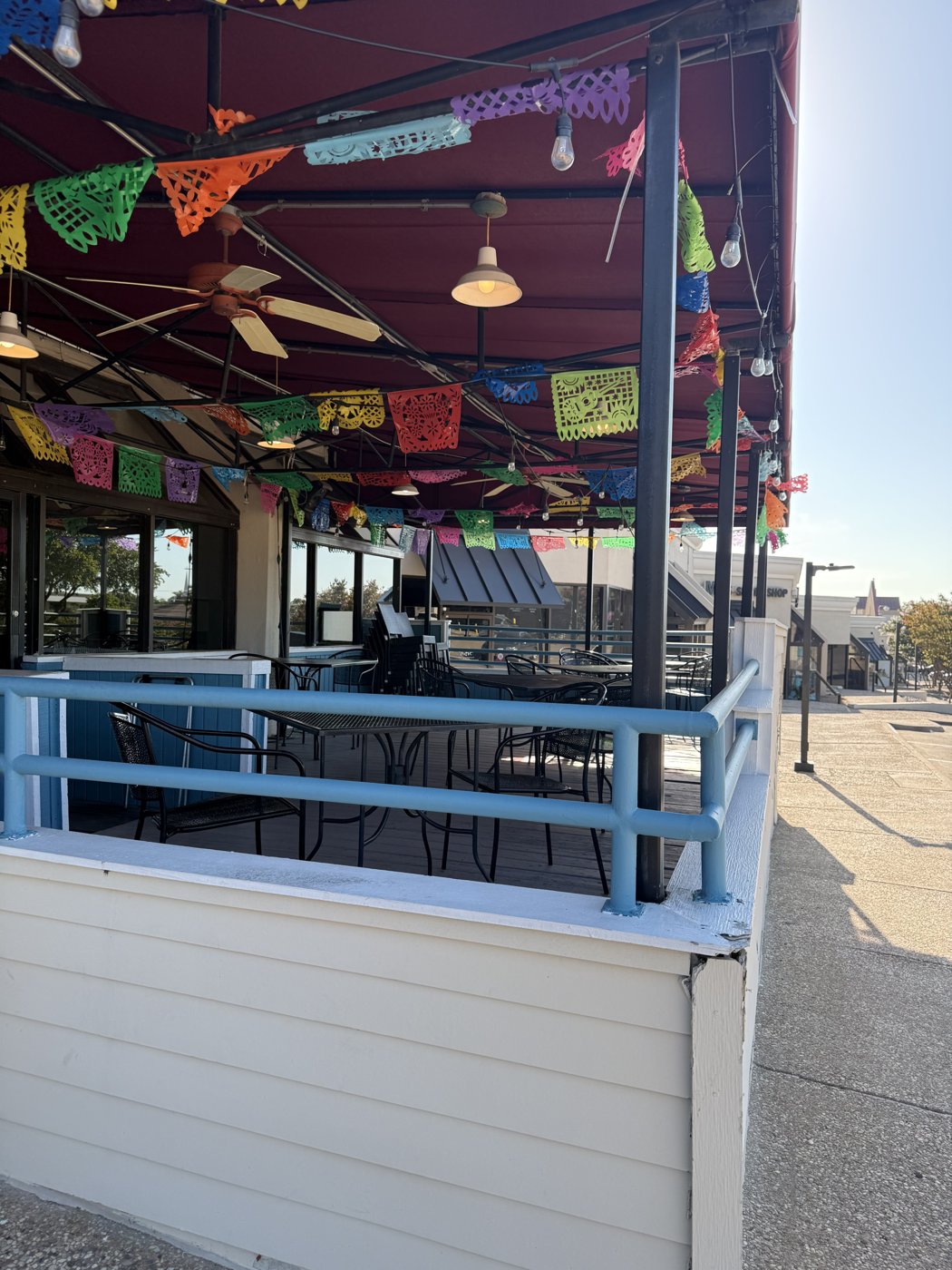 Cafe Acapulco patio seating with ceiling fans and string lights